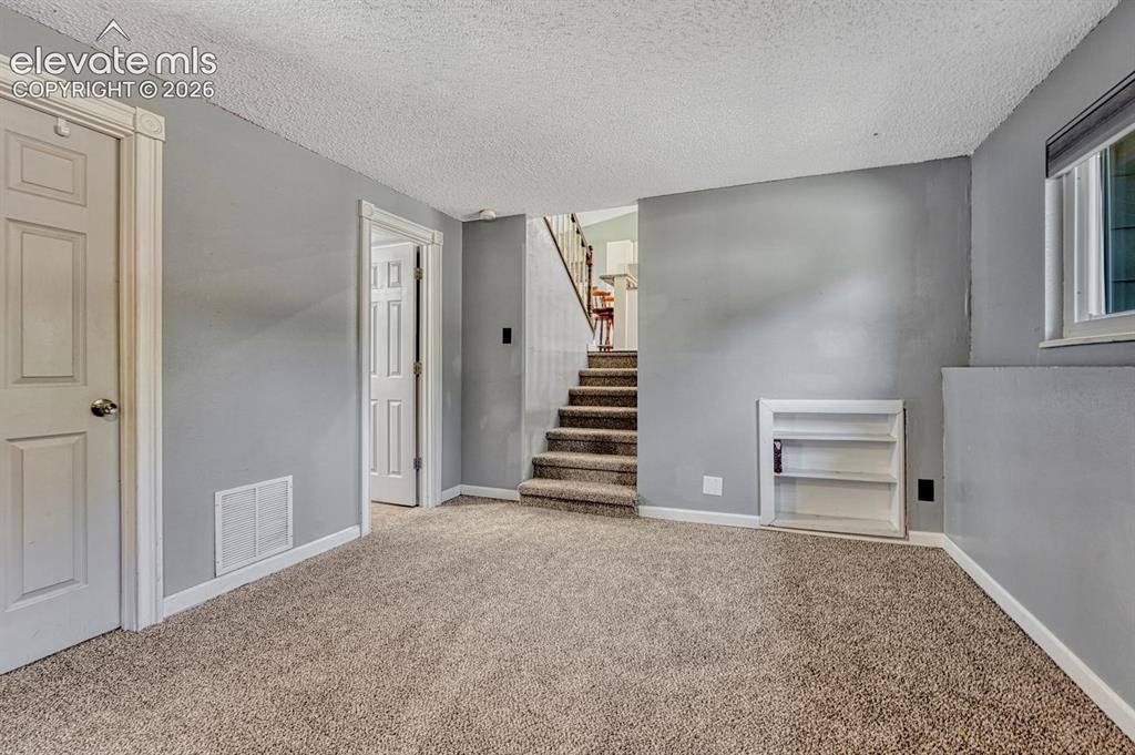 Image 15 of 50: View to the main level from the lower level Living Room.
