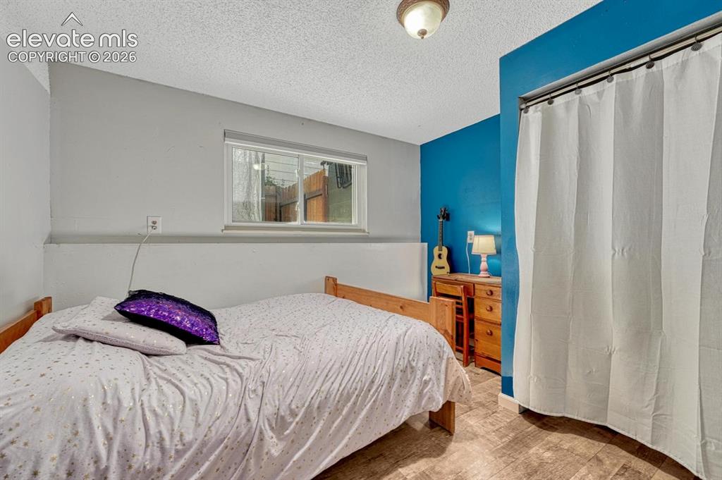 Image 18 of 50: The Lower Level Bedroom with LVP flooring offers privacy for great for gues