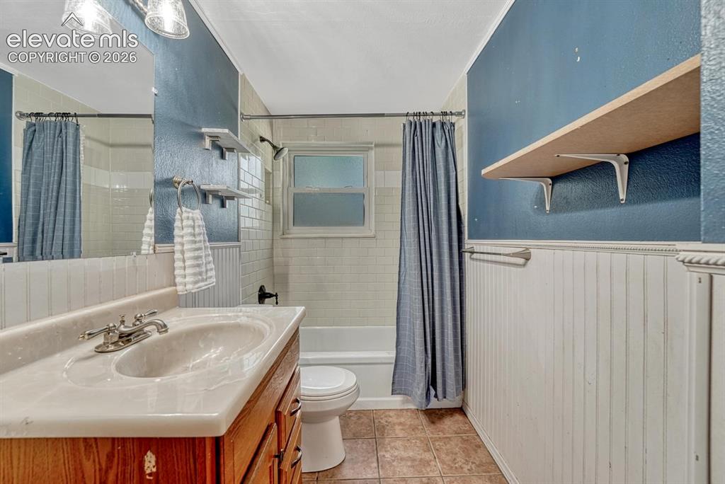 Image 20 of 50: The Lower Level Full Bathroom includes a vanity, mirror, and tiled tub/show