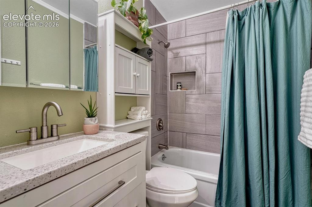 Image 25 of 50: The Upper Level Full Bathroom offers a vanity, mirrored medicine cabinet, o