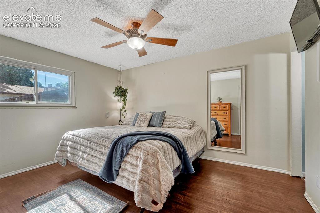 Image 28 of 50: The private Primary Suite features dual closets, a ceiling fan, & an adjoin