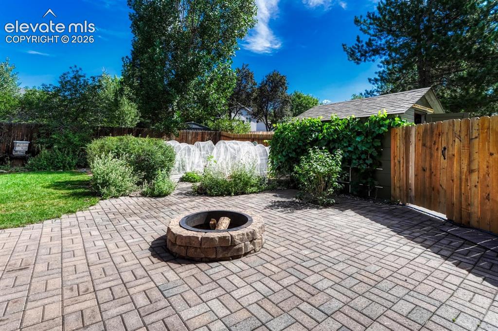 Image 35 of 50: Paver patio with firepit.