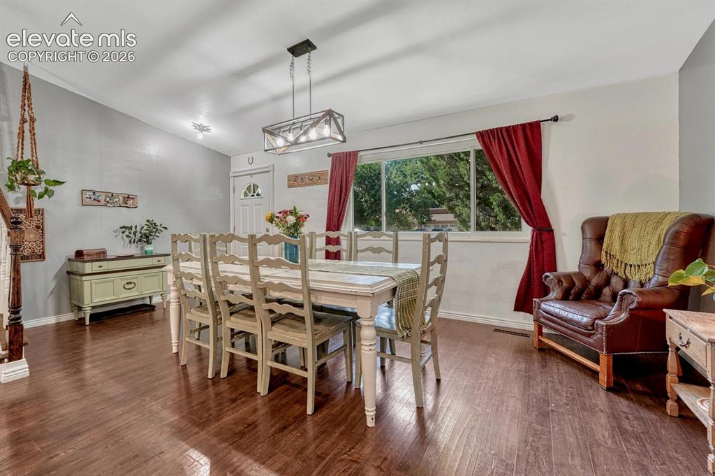 Image 4 of 50: The spacious Dining Room opens into the updated Kitchen and features LVP fl
