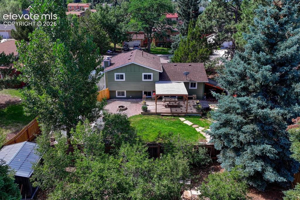 Image 45 of 50: Aerial rear view of home, backyard, and covered carport.