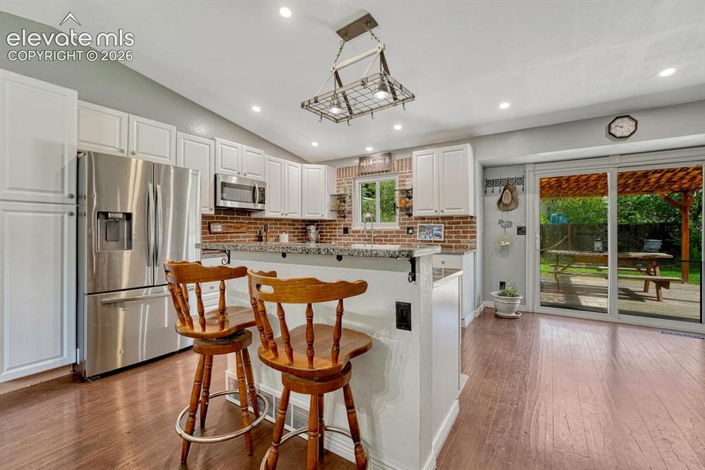 Image 8 of 50: The Kitchen offers a breakfast bar and eat-in nook for informal dining.