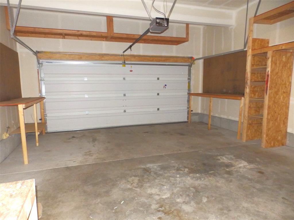 Image 15 of 16: Oversize garage with workspace