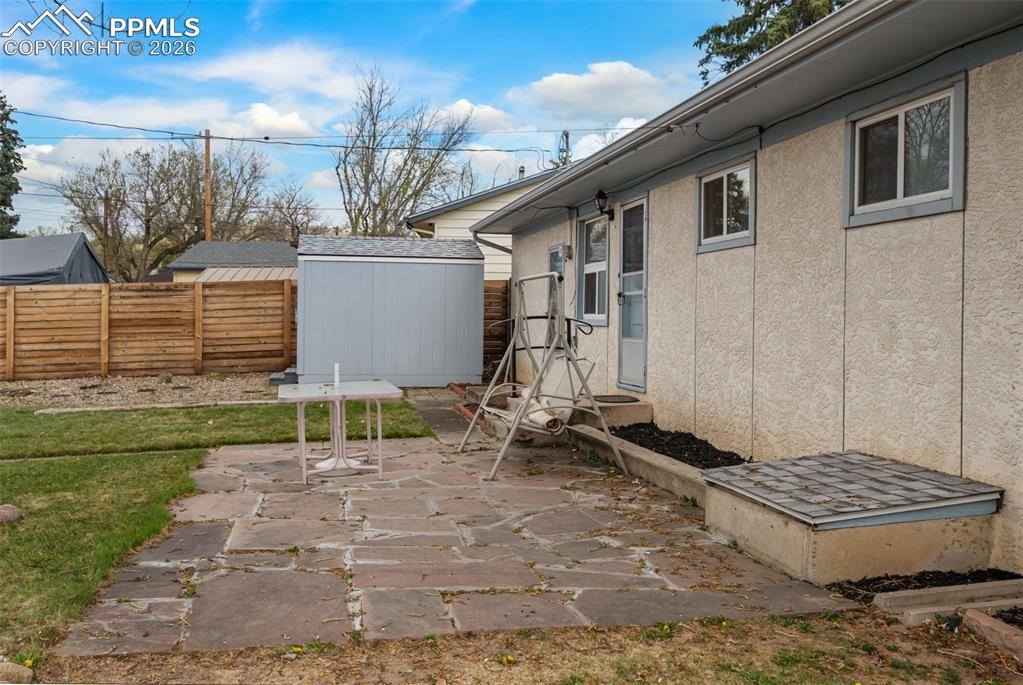 Image 24 of 28: Flagstone patio, storage shed in the back of the photo