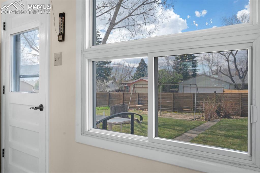 Image 7 of 28: Window view of the back yard from the dining area