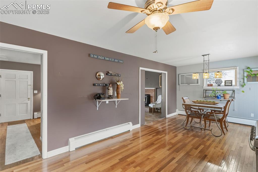Image 11 of 37: Dining space featuring baseboard heating, light wood-type flooring, and a c