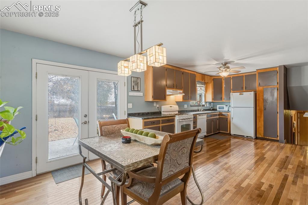 Image 12 of 37: Dining room with light wood-type flooring, french doors, and ceiling fan
