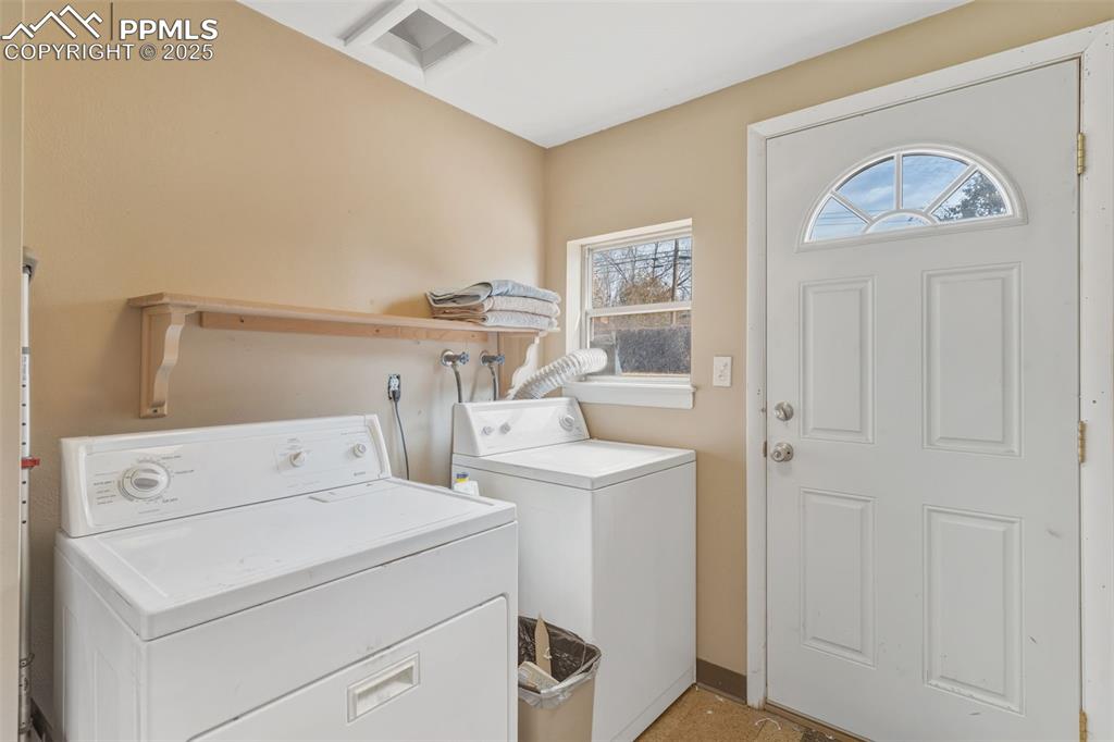 Image 25 of 37: Laundry room featuring washer and dryer and walk-out to backyard