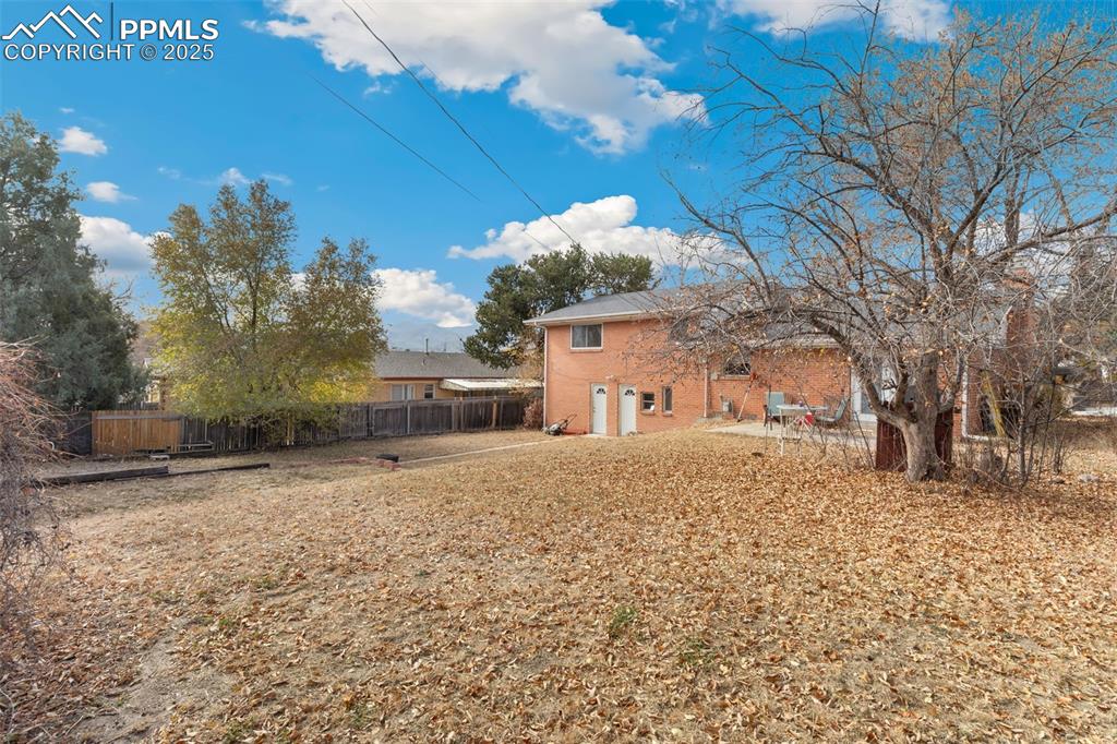 Image 4 of 37: Rear view of house with brick siding