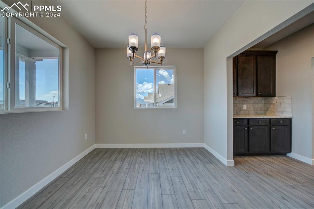 Image 11 of 47: Unfurnished dining area featuring light hardwood / wood-style floors and a