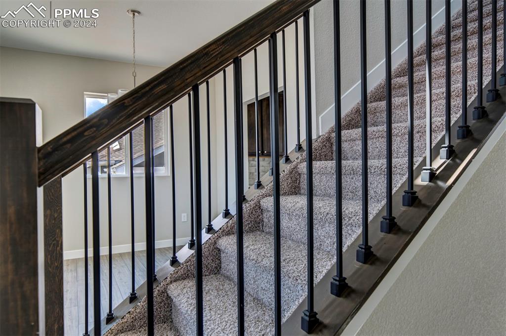 Image 15 of 47: Stairs featuring wood-type flooring