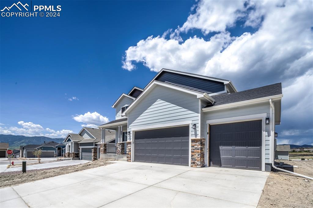 Image 2 of 47: Craftsman-style house with a garage