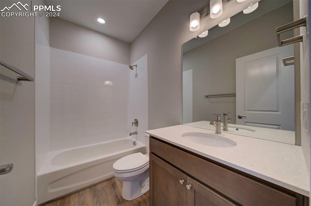 Image 20 of 47: Full bathroom featuring bathing tub / shower combination, toilet, vanity, a