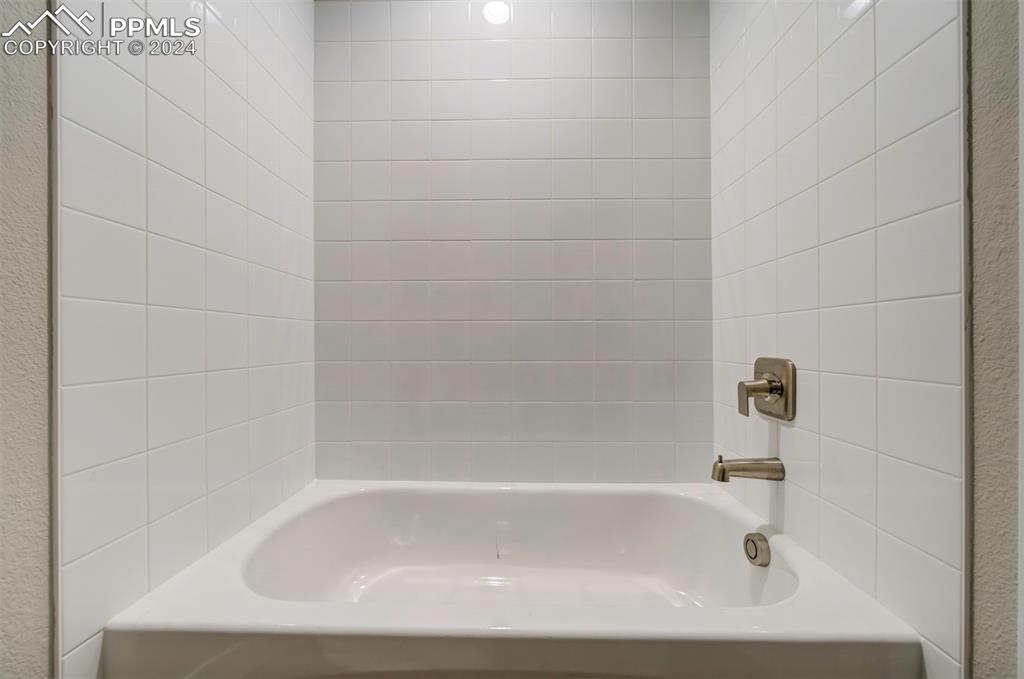 Image 21 of 47: Bathroom featuring tiled shower / bath