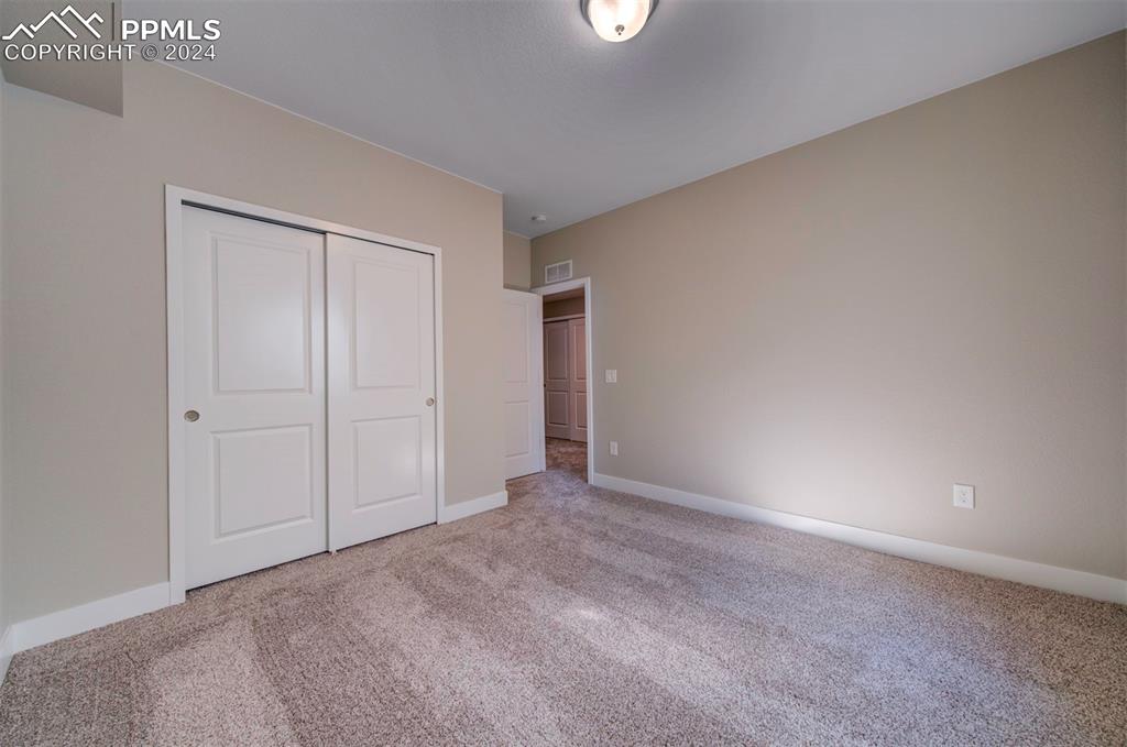 Image 29 of 47: Unfurnished bedroom featuring a closet and light carpet