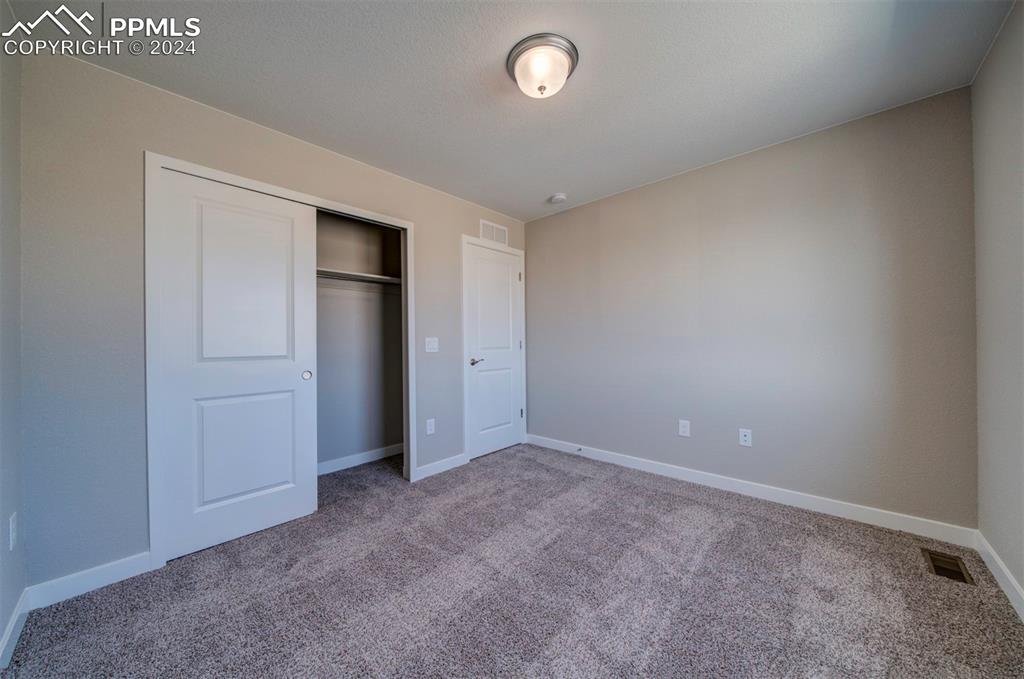 Image 33 of 47: Unfurnished bedroom with a closet and carpet