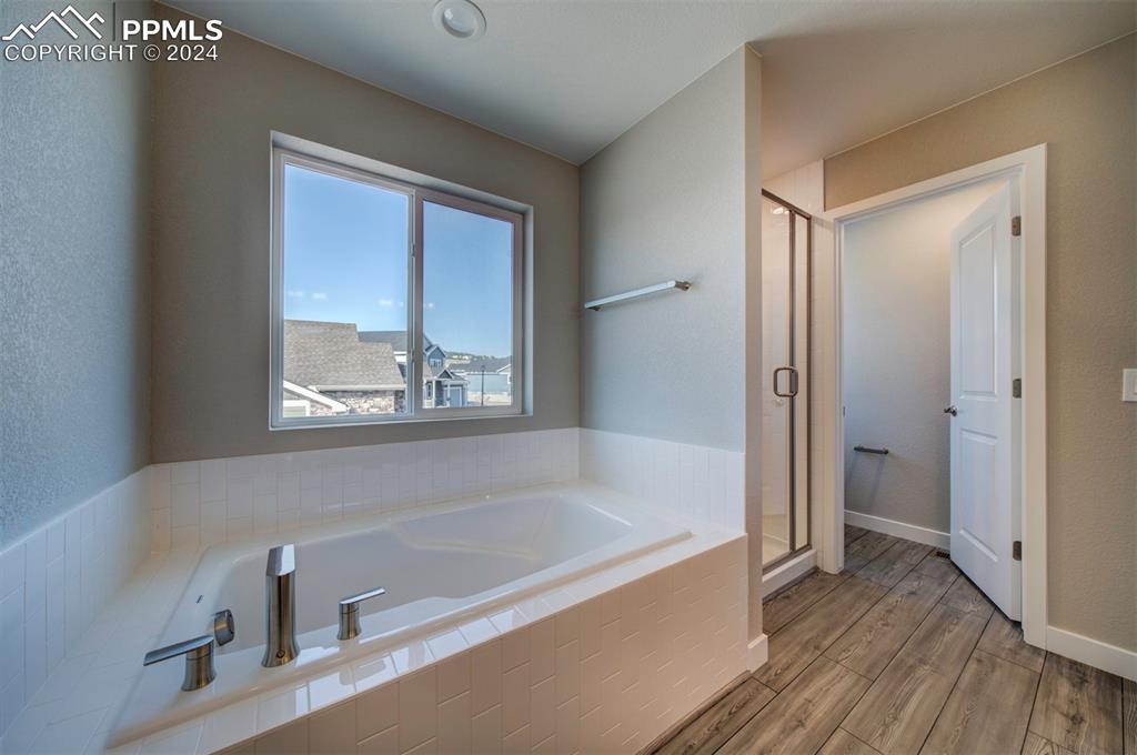 Image 36 of 47: Bathroom featuring hardwood / wood-style flooring and independent shower an