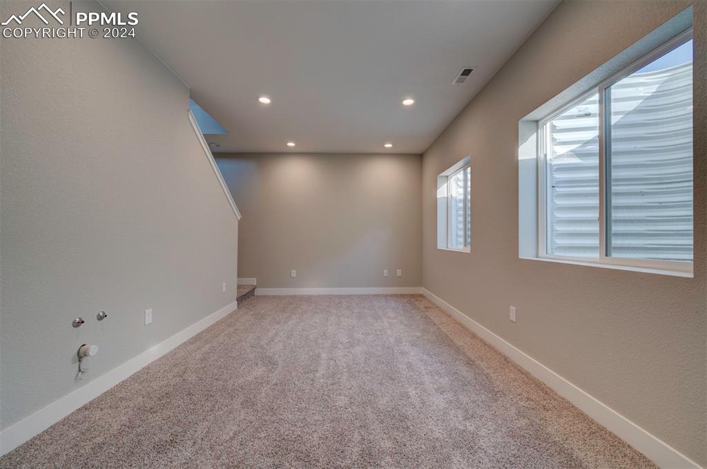 Image 45 of 47: Unfurnished room with carpet floors