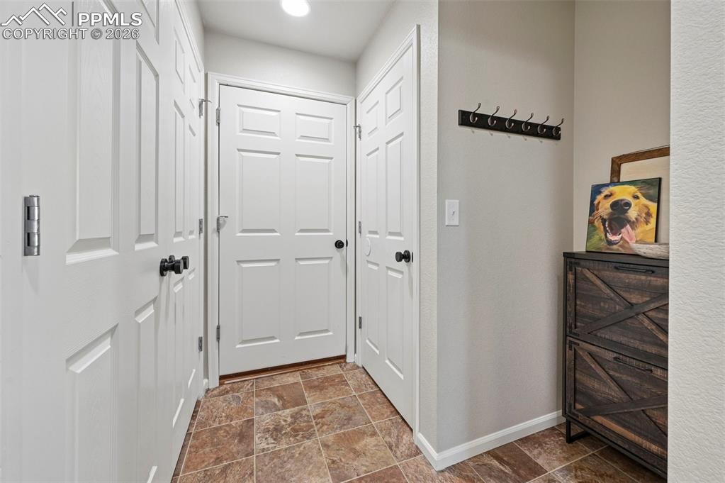 Image 15 of 35: Entry from garage, utility closet, and entry to basement
