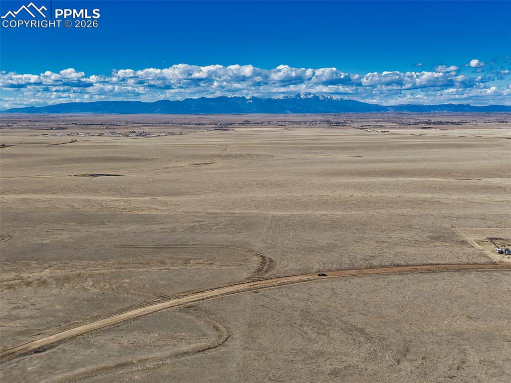 Caption: Aerial View – Mountain Backdrop
Expansive aerial view showcasing the level 2.95-acre parcel with sw