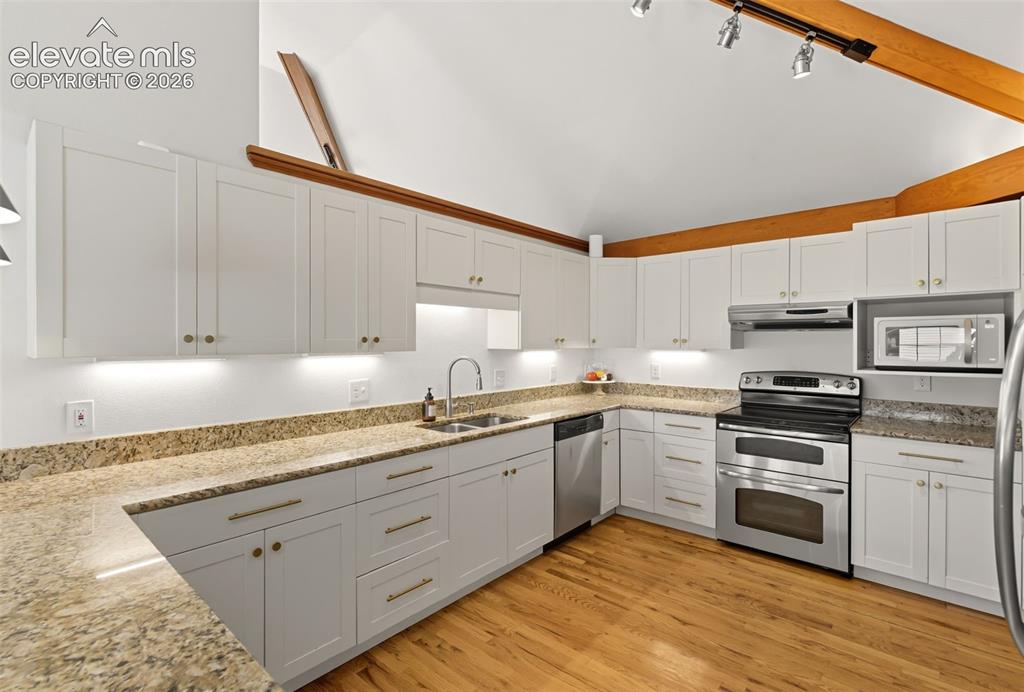 Image 20 of 50: Kitchen cabinets were repainted to give them a more modern look