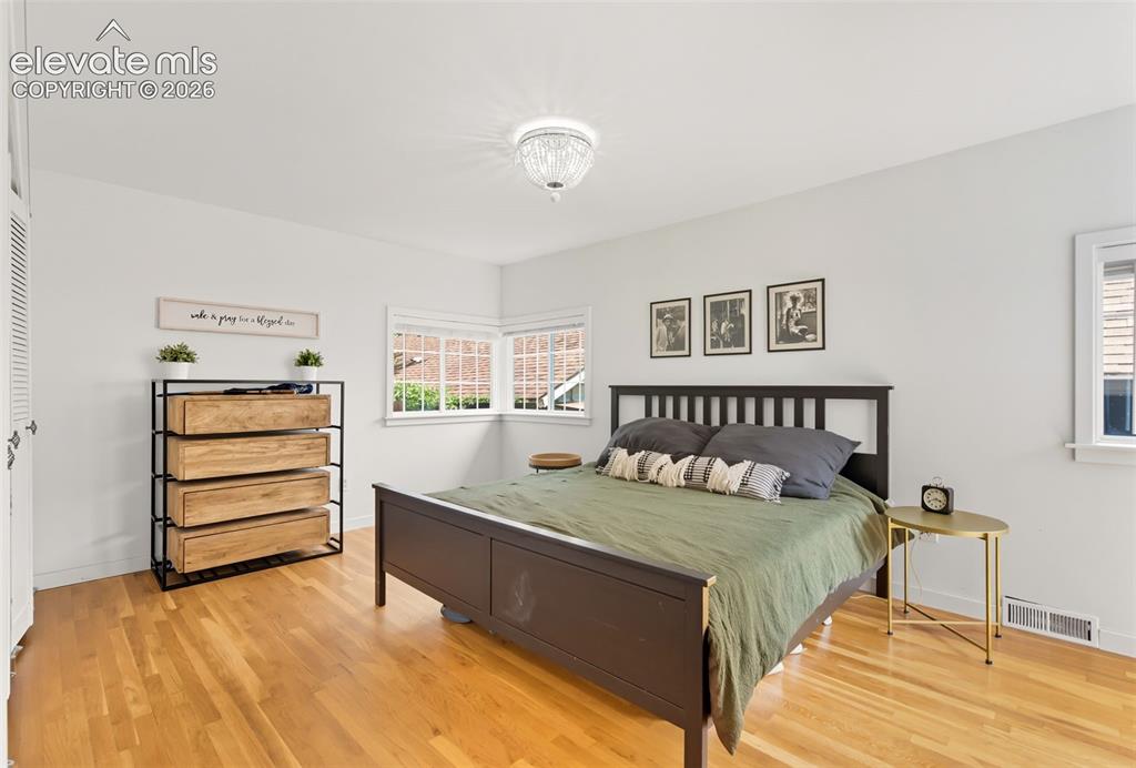 Image 23 of 50: Primary bedroom has oak floors
