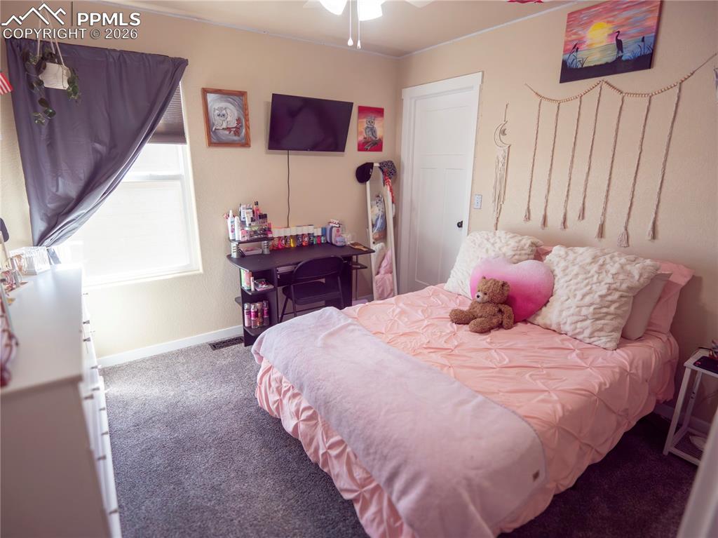 Image 18 of 32: Carpeted bedroom featuring baseboards and ceiling fan