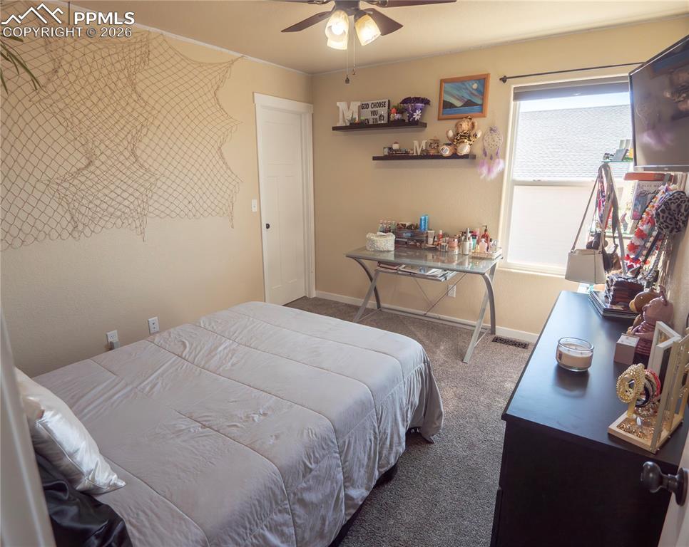 Image 19 of 32: Carpeted bedroom with baseboards and a ceiling fan