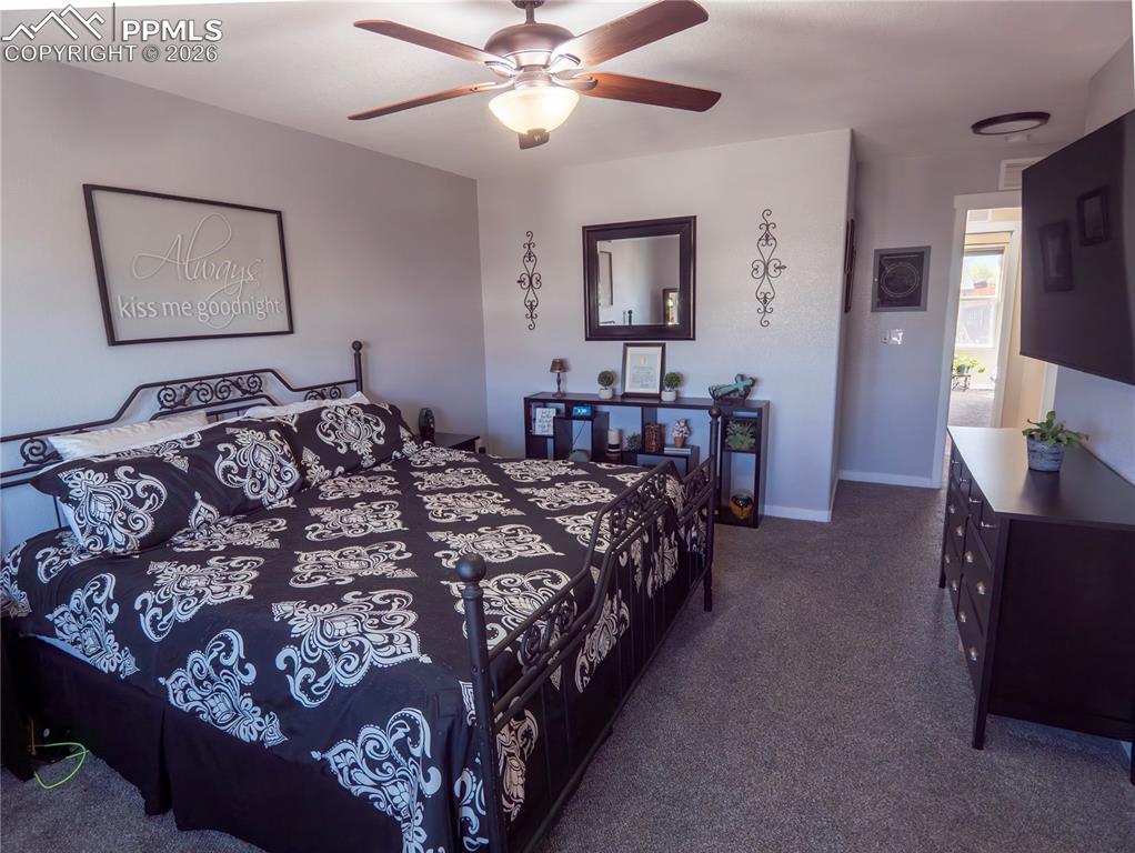Image 24 of 32: Bedroom featuring dark colored carpet and a ceiling fan