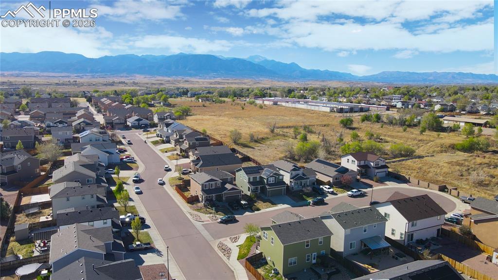 Image 32 of 32: Aerial perspective of suburban area with a mountain backdrop