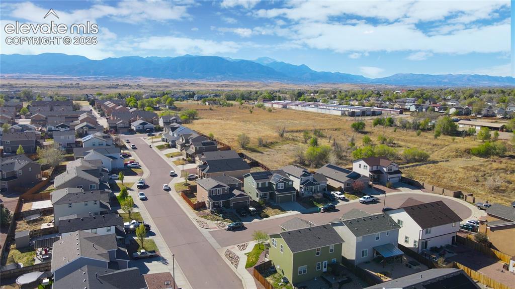 Image 33 of 33: Aerial perspective of suburban area with a mountain backdrop