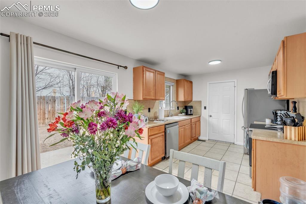 Image 15 of 44: Kitchen featuring stainless steel appliances, light tile patterned floors, 