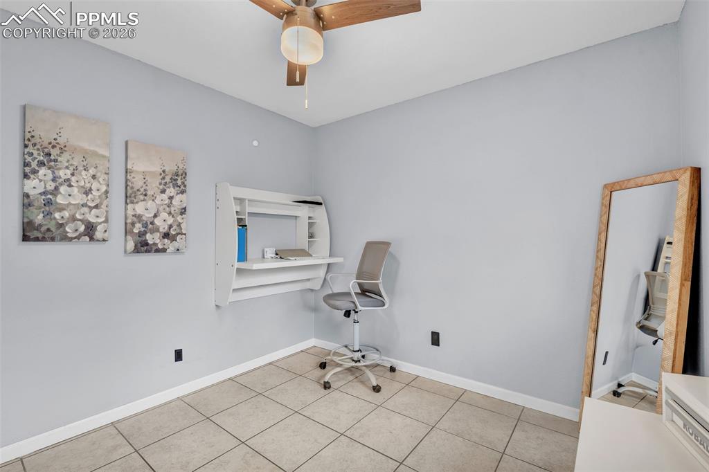 Image 31 of 44: Unfurnished office with ceiling fan and tile patterned floors
