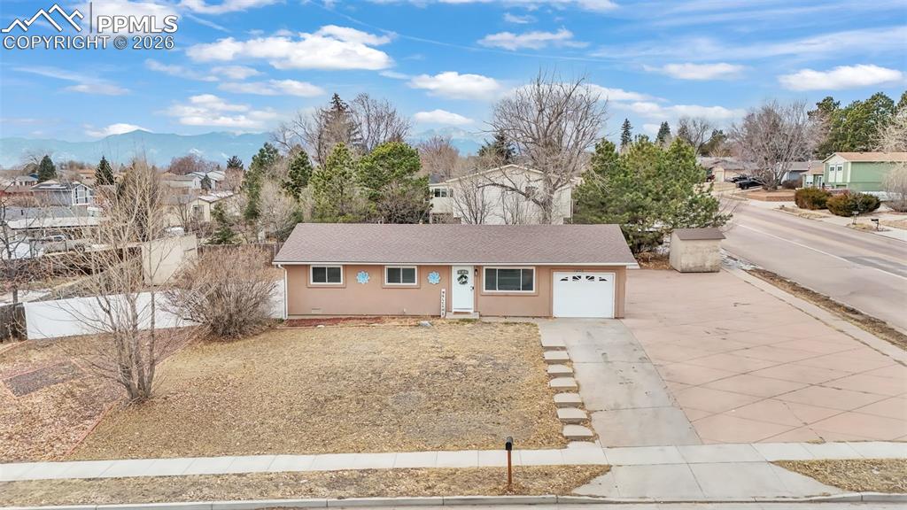 Image 38 of 44: Ranch-style home with concrete driveway, stucco siding, a garage, a residen
