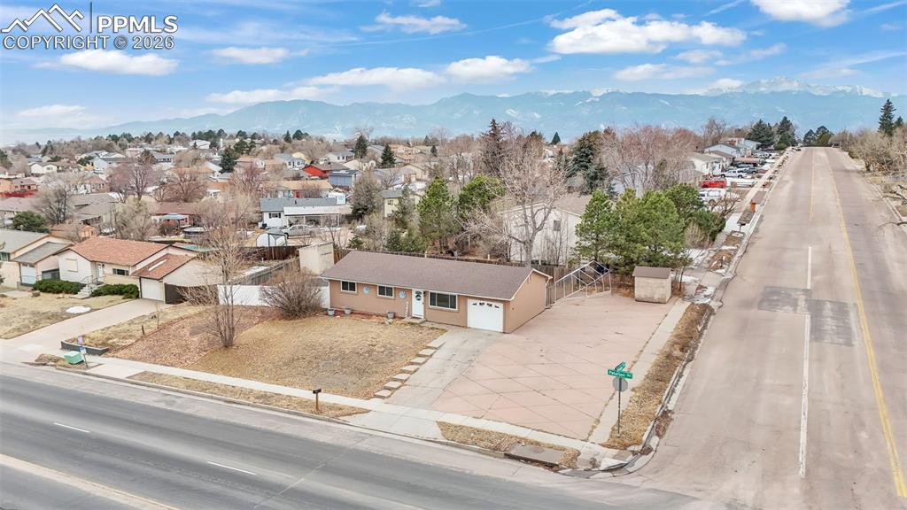 Image 39 of 44: Aerial perspective of suburban area with a mountain backdrop