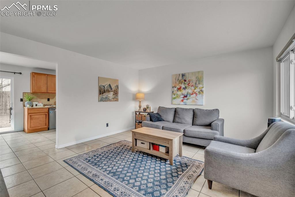 Image 6 of 44: Living area featuring light tile patterned floors and baseboards
