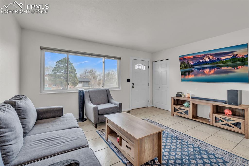 Image 8 of 44: Living room with light tile patterned floors