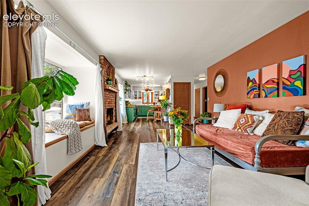 Image 15 of 38: Spacious living area featuring wood-finish flooring, a built-in window seat