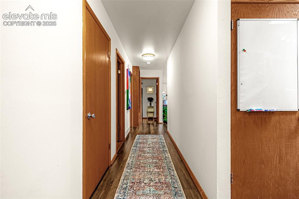 Image 23 of 38: Hallway featuring wood-finish flooring, light-toned walls, and recessed lig