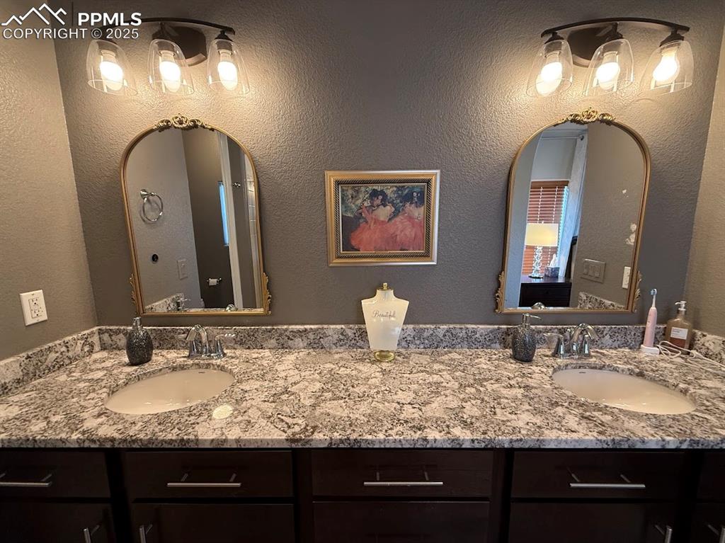Image 16 of 40: Full bathroom featuring double vanity and a sink