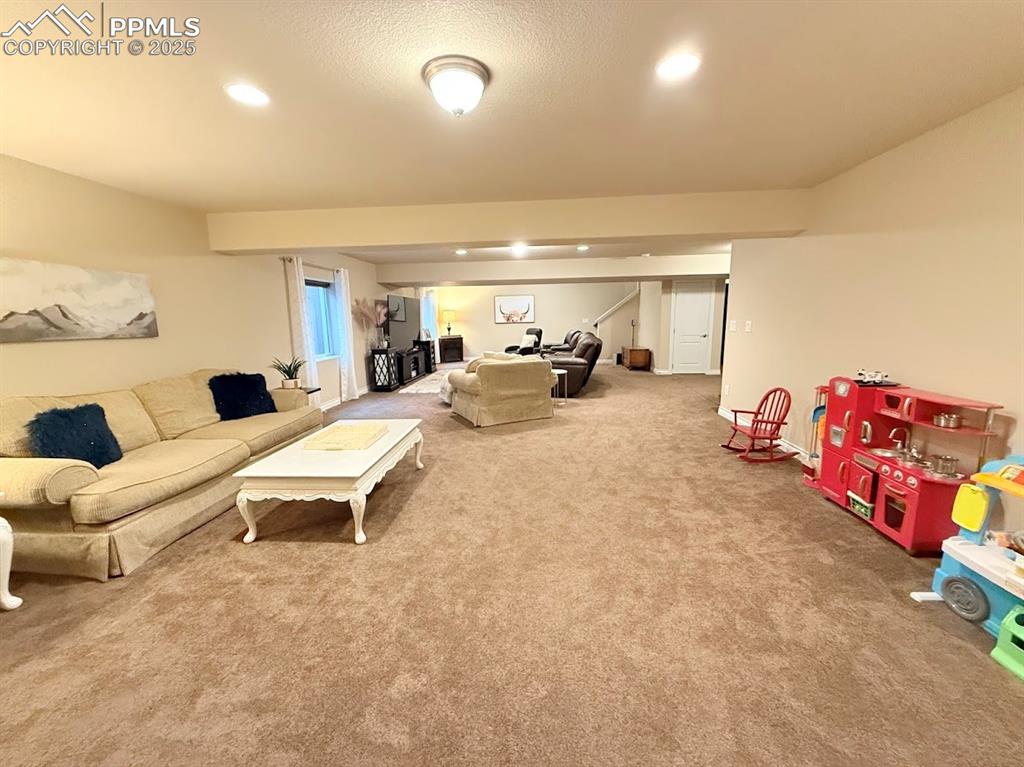 Image 18 of 40: Carpeted living room with recessed lighting