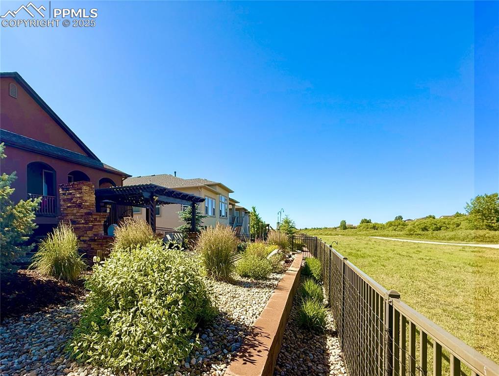 Image 28 of 40: View of yard with a pergola