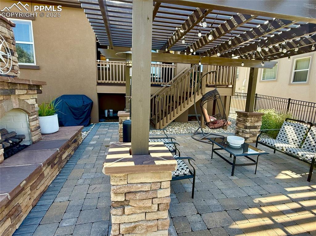 Image 30 of 40: View of patio featuring stairway and a pergola
