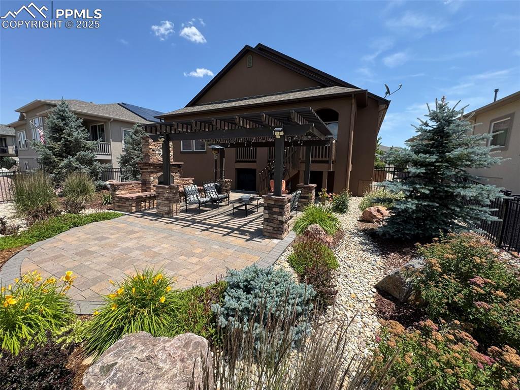 Image 37 of 40: Back of property featuring a patio area, stucco siding, and a pergola