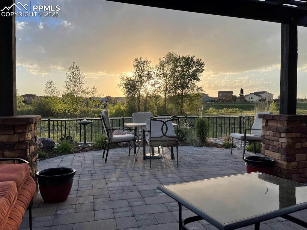 Image 39 of 40: Patio terrace at dusk with outdoor dining space