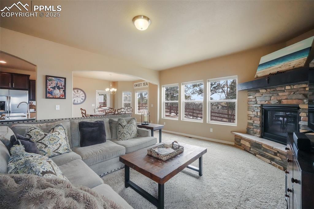 Image 13 of 50: Open concept living room with mountain views, natural light and gas firepla