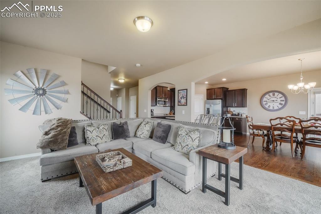 Image 15 of 50: Open concept living room with mountain views, natural light and gas firepla